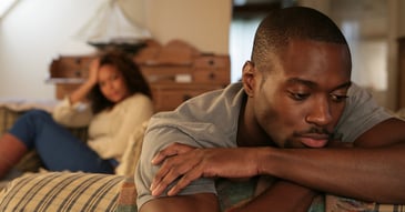 Black man feeling isolated and guarded from female partner. 