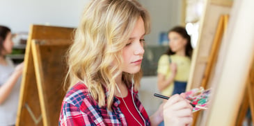 young girl painting in expressive therapy