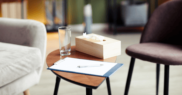 therapist notebook, tissues, and water for counseling session