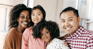 Blended family smiling for support group.
