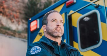 serious man in front of ambulance
