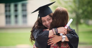 High school graduate hugging mom