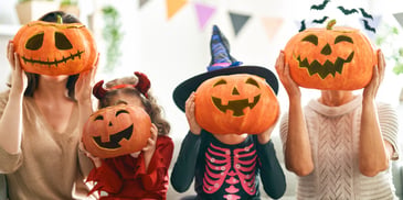 fun halloween pumpkins in front of costumed tween girl faces