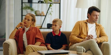 Divorced family in therapy with child in the middle