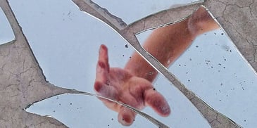hands on the broken glass