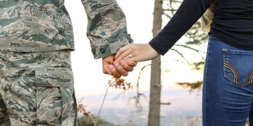 holding hand with a soldier