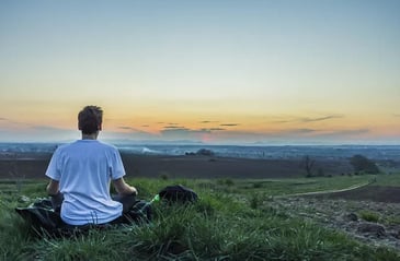 A young man in the wilderness meditating