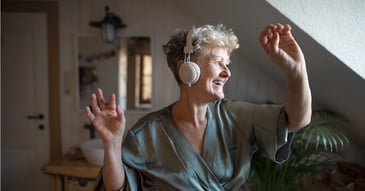 old woman enjoying music