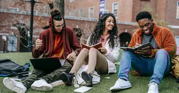 young college kids studying and laughing outside