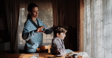 Mother caregiving for child in dim room
