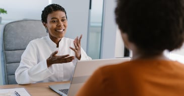 woman in white discussing adding meds to mental health therapy