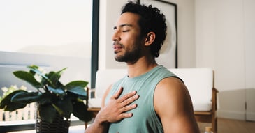 Man with eyes closed and hand on heart, preparing for emdr and emotional healing