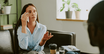 young adult woman crying at work and feeling burned out