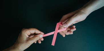 Photo by Ave Calvar Martinez: https://www.pexels.com/photo/hands-holding-breast-cancer-pink-paper-ribbon-5072316/