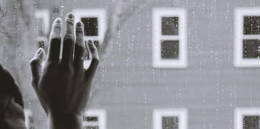 a hand touching the window