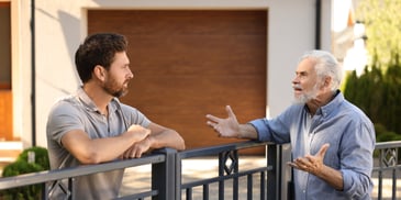 older dad frustrated with young adult son moving home after college