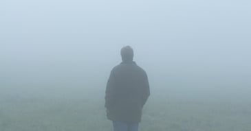solitary sad figure in a fog