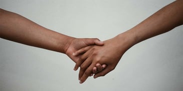 A hand holding another hand