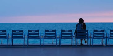 a woman alone sitting in the docks