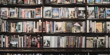 Books on a shelf. Photo by <a href=