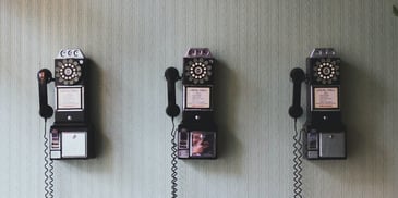 Phones in a line. Photo by <a href=