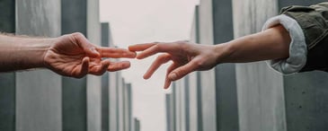 Two people touching hands. Photo by <a href=