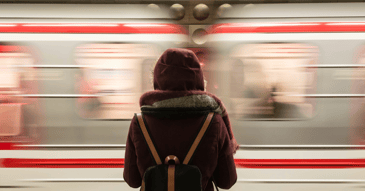 stressed culture shocked traveler facing speeding train