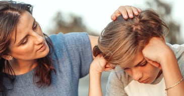 Mother comforting son worried about school violence