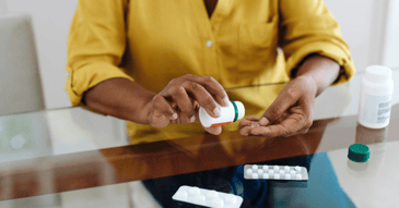hands holding prescription pill bottle 
