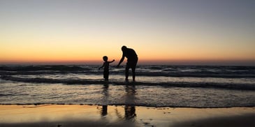 A father with his child enjoying the beach