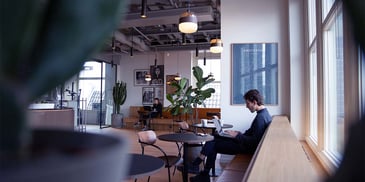 Person sitting in coffee shop. Photo by <a href=