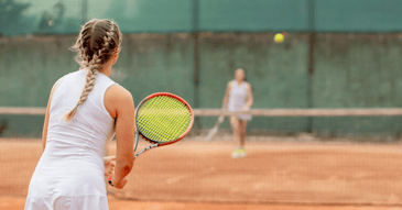 close up of girls playing tennis