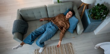 anxious woman sinking into couch